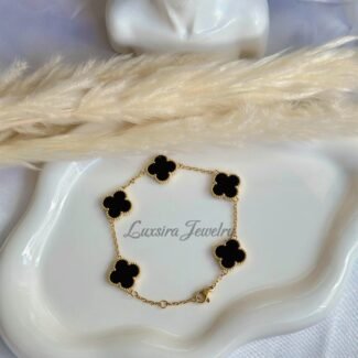 18K gold plated bracelet with black clover charm on white display