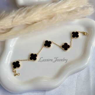 Women's black clover bracelet in 18K gold plated finish.